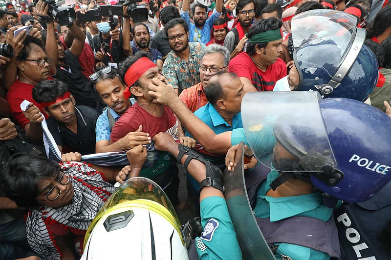 A policeman stops a  cultural activist from talking on 30 July 2024